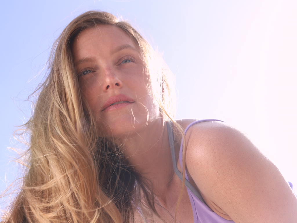 Woman stretching outdoors at sunrise