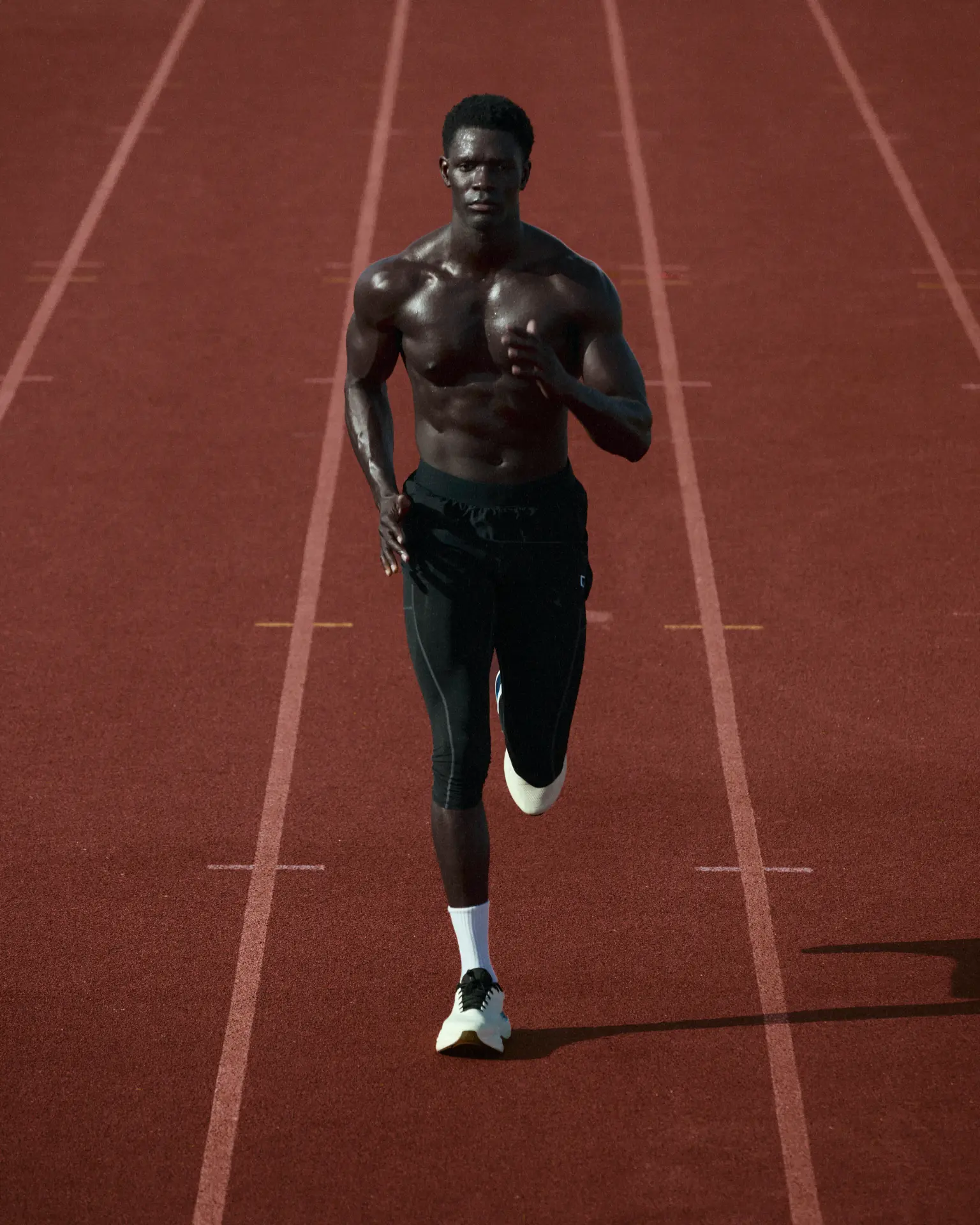 Athlete running on a red track